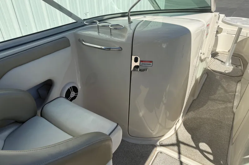 Slide: The Image of 2007 Sea Ray 270 Sundeck interior with seating, cup holders, and storage compartment. - 14