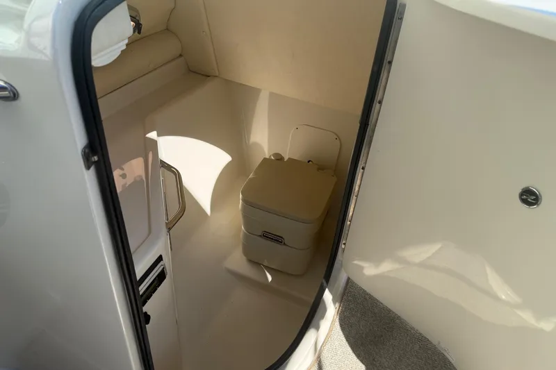 Slide: The Image of 2007 Sea Ray 270 Sundeck interior with compact marine toilet. - 15