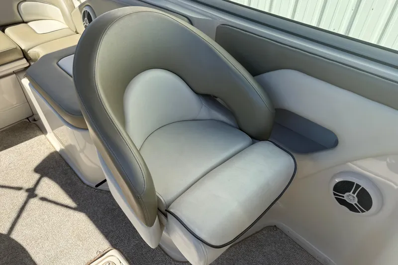 Slide: The Image of 2007 Sea Ray 270 Sundeck interior with cushioned seating and speaker detail. - 16