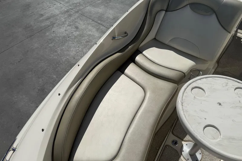 Slide: The Image of 2007 Sea Ray 270 Sundeck interior with cushioned seating and round table. - 21