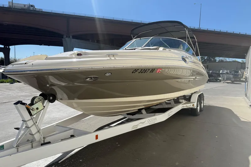 Slide: The Image of 2007 Sea Ray 270 Sundeck boat on trailer under bridge, sunny day. - 3