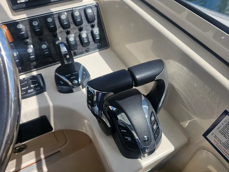 Slide: The Image of 2022 Grady-White Freedom 275 boat controls and dashboard. - 15