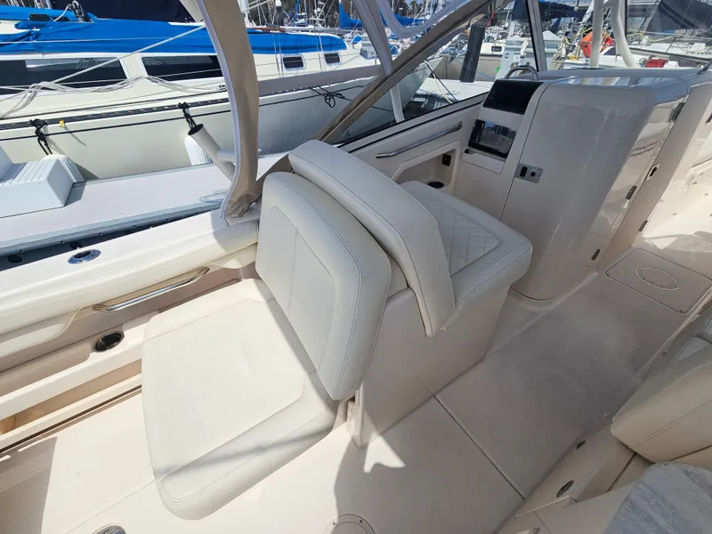 Slide: The Image of Interior of a 2022 Grady-White Freedom 275 boat at the marina. - 19