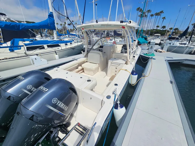 Slide: The Image of 2022 Grady-White Freedom 275 boat docked with Yamaha engines. - 2