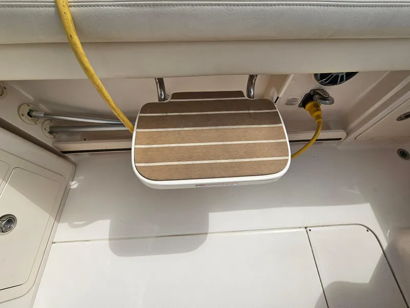 Slide: The Image of 2022 Grady-White Freedom 275 boat with wooden deck and yellow cable. - 22