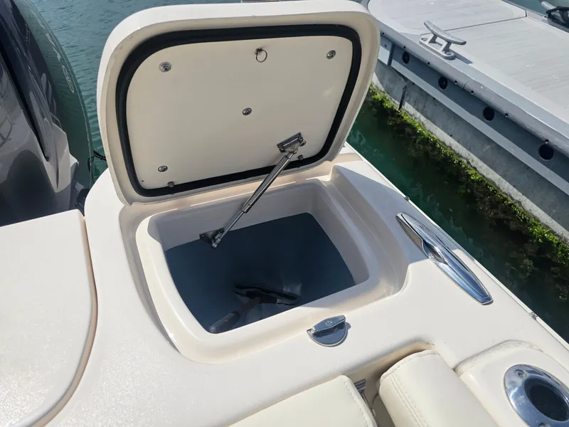 Slide: The Image of Open storage compartment on a 2022 Grady-White Freedom 275 boat. - 25