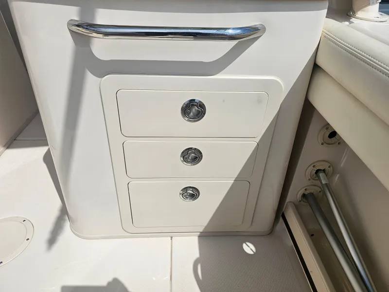 Slide: The Image of Interior of 2022 Grady-White Freedom 275 with drawers and stainless steel handle. - 27