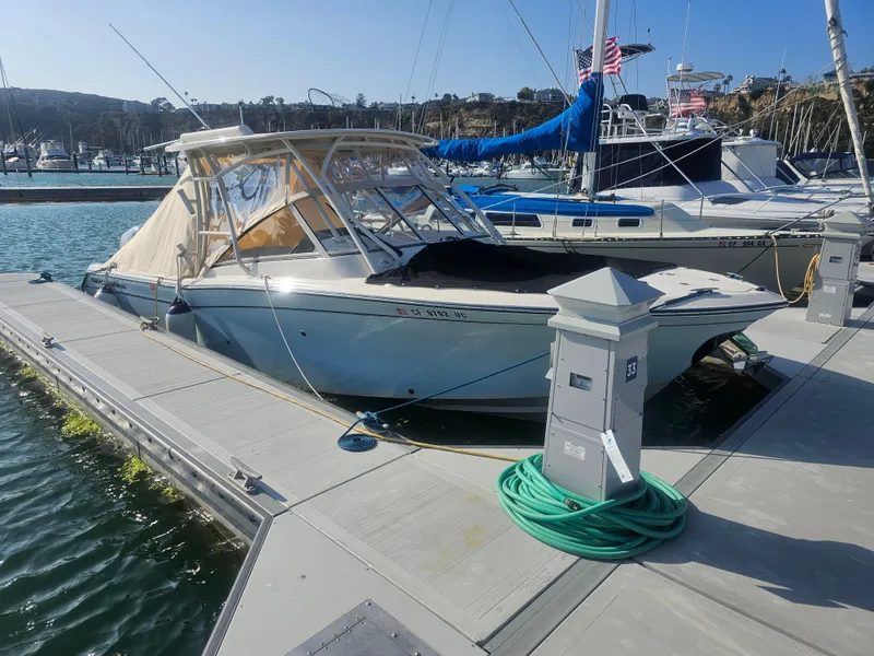 Slide: The Image of 2022 Grady-White Freedom 275 boat docked at marina. - 38