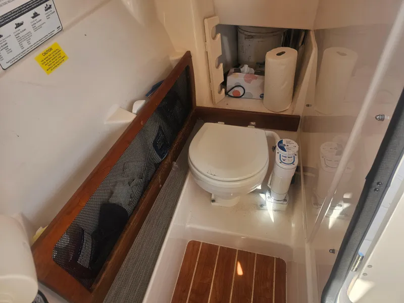 Slide: The Image of Interior of 2022 Grady-White Freedom 275 with toilet and storage area. - 44