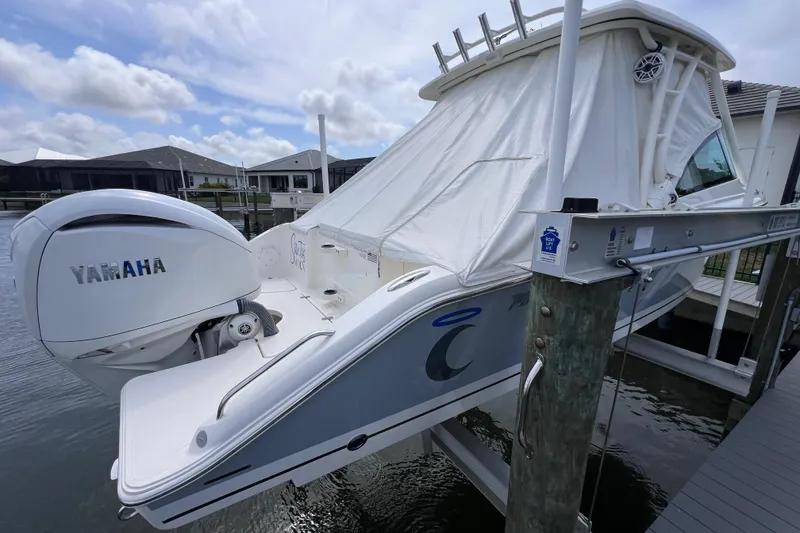 Slide: The Image of 2022 Pursuit DC 246 Dual Console boat with Yamaha engine on a lift. - 10