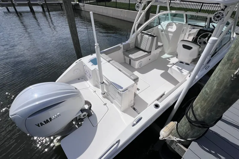 Slide: The Image of 2022 Pursuit DC 246 Dual Console boat docked, featuring Yamaha outboard motor. - 14