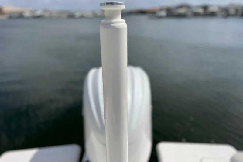 Slide: The Image of Close-up of a 2022 Pursuit DC 246 Dual Console boat detail with water background. - 17