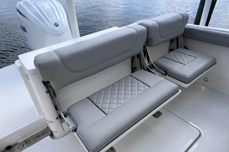 Slide: The Image of 2022 Pursuit DC 246 Dual Console boat with luxurious gray seating and sleek design. - 23