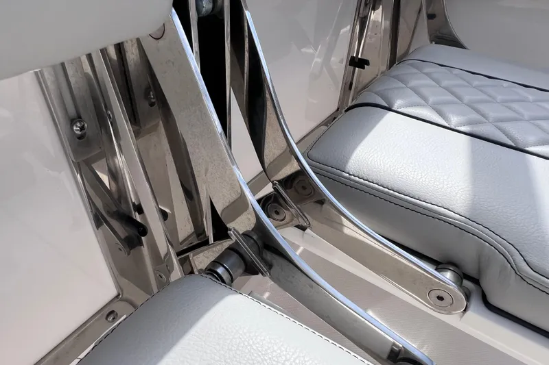 Slide: The Image of 2022 Pursuit DC 246 Dual Console boat seating with stainless steel hardware and white upholstery. - 26