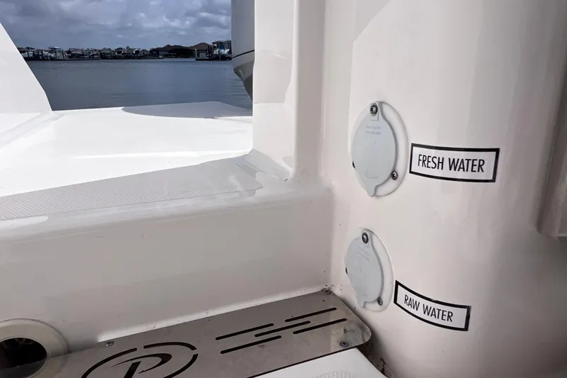 Slide: The Image of 2022 Pursuit DC 246 Dual Console boat with fresh and raw water access. - 27