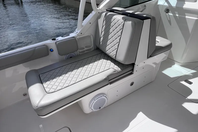 Slide: The Image of 2022 Pursuit DC 246 Dual Console boat interior with luxurious seating and cup holders. - 30