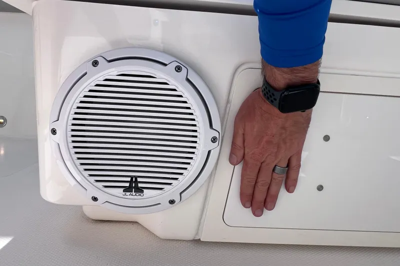 Slide: The Image of Hand near JL Audio speaker on 2022 Pursuit DC 246 Dual Console boat. - 31
