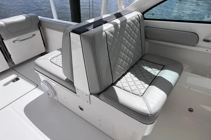 Slide: The Image of 2022 Pursuit DC 246 Dual Console boat interior with quilted seating and sleek design. - 32