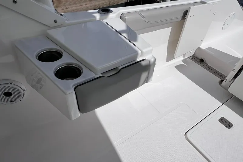 Slide: The Image of 2022 Pursuit DC 246 Dual Console boat interior with cup holders and seating area. - 34