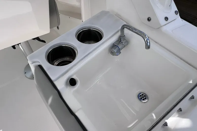 Slide: The Image of 2022 Pursuit DC 246 Dual Console boat sink and cup holders. - 35