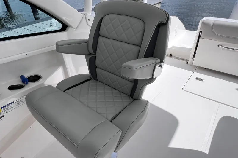 Slide: The Image of Luxury seating on 2022 Pursuit DC 246 Dual Console boat, featuring quilted gray upholstery. - 36