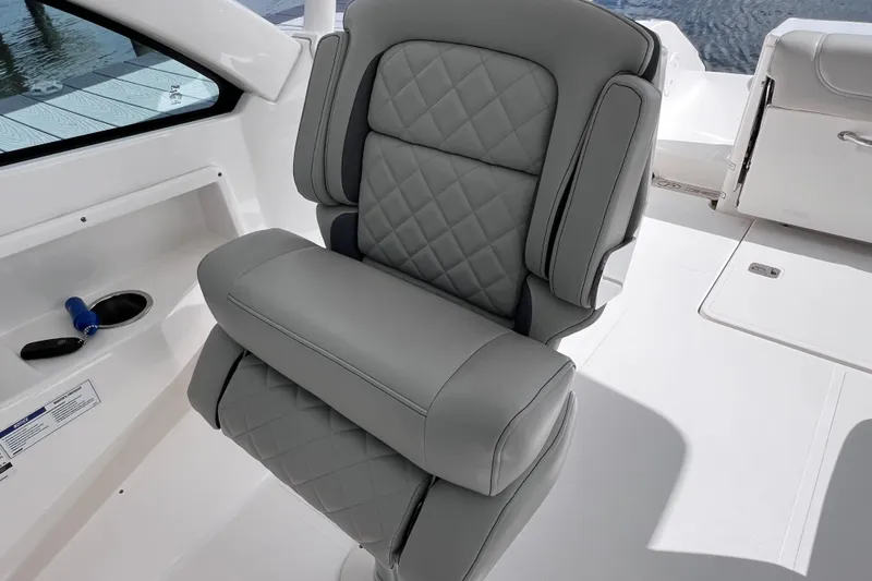 Slide: The Image of 2022 Pursuit DC 246 Dual Console boat seat with quilted gray upholstery. - 37
