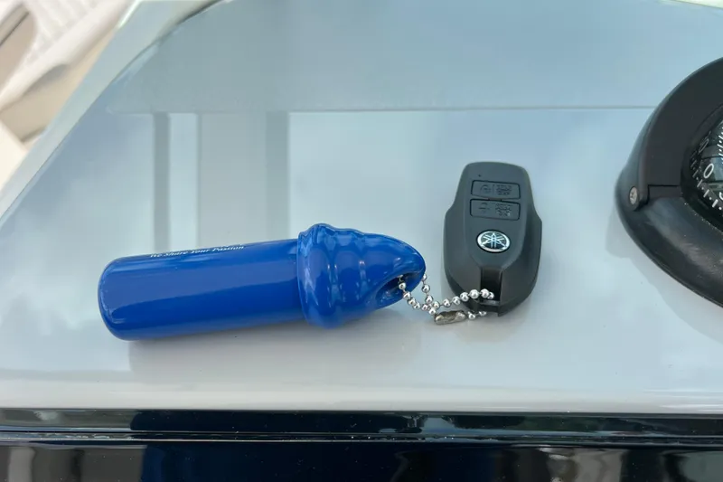 Slide: The Image of Blue safety lanyard and key fob on 2022 Pursuit DC 246 Dual Console boat. - 40