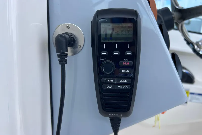 Slide: The Image of Garmin marine radio on 2022 Pursuit DC 246 Dual Console boat dashboard. - 46