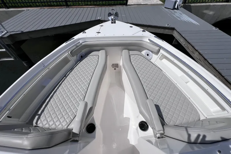 Slide: The Image of 2022 Pursuit DC 246 Dual Console boat with luxurious seating at dock. - 51