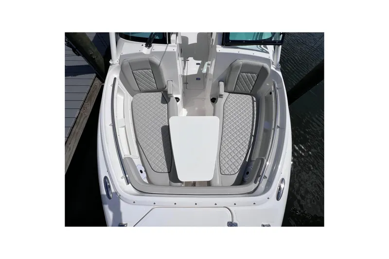 Slide: The Image of 2022 Pursuit DC 246 Dual Console boat interior with gray seating and table. - 54