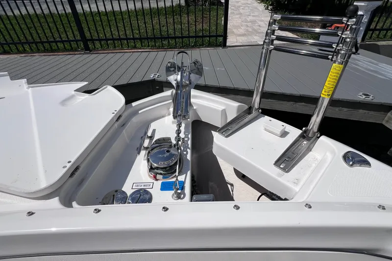 Slide: The Image of 2022 Pursuit DC 246 Dual Console boat anchor compartment with ladder and fresh water access. - 60