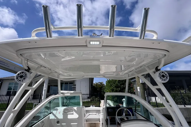 Slide: The Image of 2022 Pursuit DC 246 Dual Console boat interior with speakers and rod holders. - 64