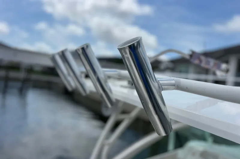 Slide: The Image of Close-up of rod holders on a 2022 Pursuit DC 246 Dual Console boat. - 65