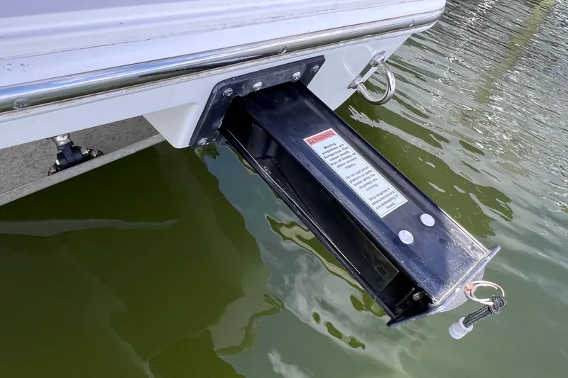 Slide: The Image of 2022 Pursuit DC 246 Dual Console boat with extended swim platform over water. - 69