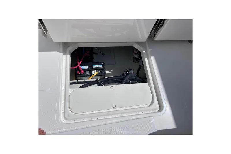 Slide: The Image of 2022 Pursuit DC 246 Dual Console boat battery compartment with wiring. - 70