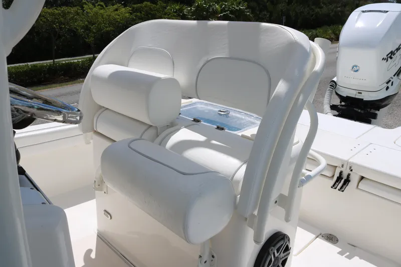 Slide: The Image of 2019 ShearWater 26 Carolina boat interior with white seating and steering wheel. - 10