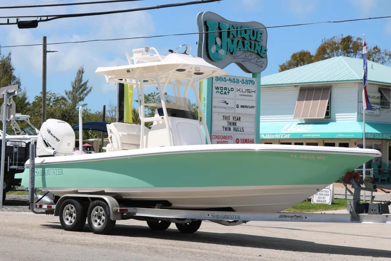 Slide: The Image of 2019 ShearWater 26 Carolina boat on trailer at Unique Marine dealership. - 3