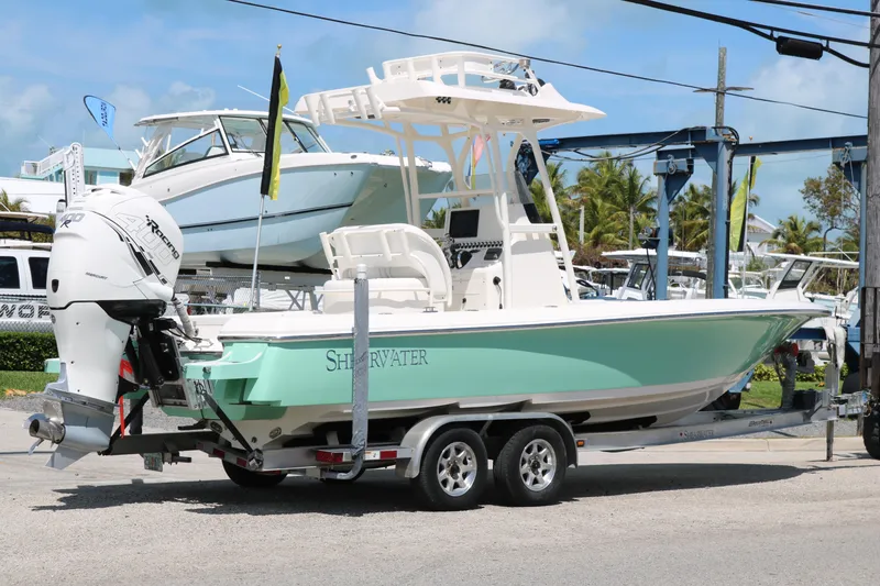 Slide: The Image of 2019 ShearWater 26 Carolina boat on trailer, featuring sleek design and powerful outboard motor. - 4
