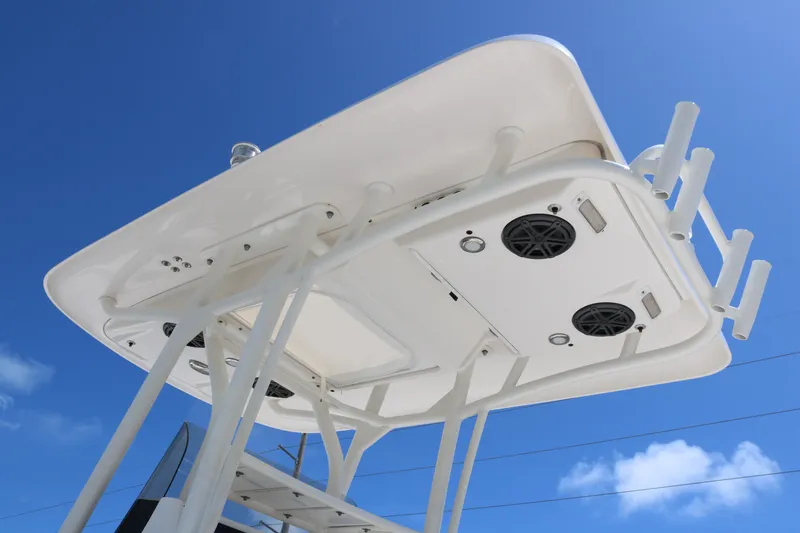 Slide: The Image of 2019 ShearWater 26 Carolina boat top view with speakers against blue sky. - 6