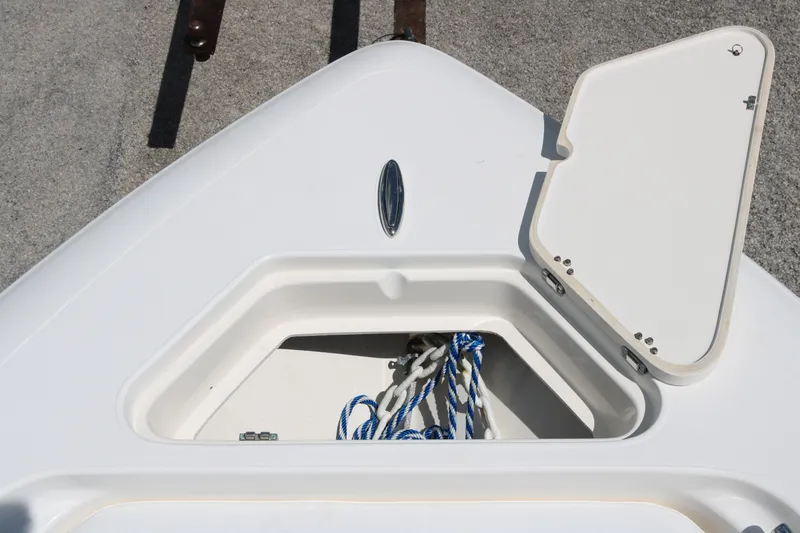 Slide: The Image of Open storage compartment on 2019 ShearWater 26 Carolina boat with ropes inside. - 7