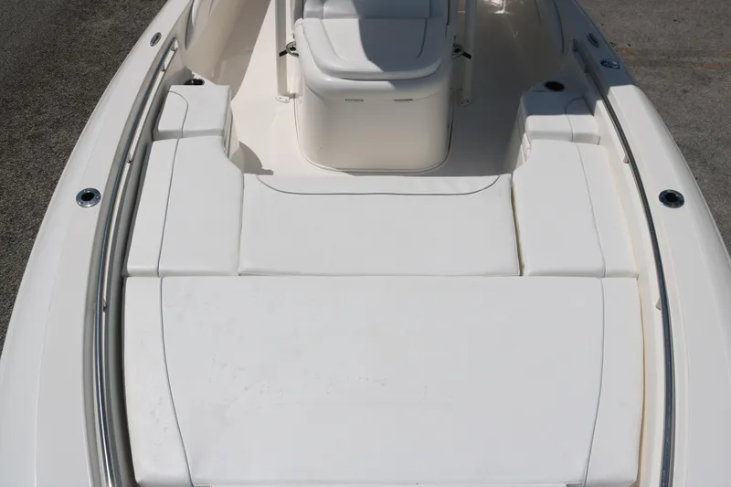 Slide: The Image of 2019 ShearWater 26 Carolina boat interior with white cushioned seating. - 8