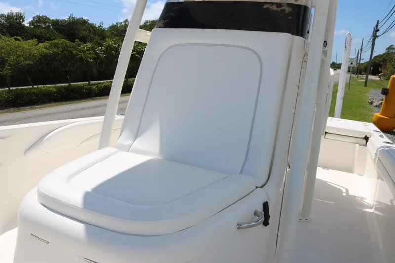 Slide: The Image of 2019 ShearWater 26 Carolina boat seat with white upholstery, outdoor setting. - 9