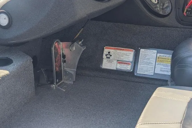 Slide: The Image of Interior of 2022 Tracker Pro Team 195 TXW Tournament Edition boat, showing foot pedal and warning labels. - 4