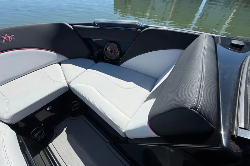 Slide: The Image of 2019 MasterCraft XT22 boat interior with sleek seating and modern design. - 13