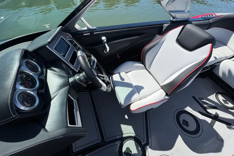 Slide: The Image of 2019 MasterCraft XT22 boat interior with sleek dashboard and modern seating. - 16