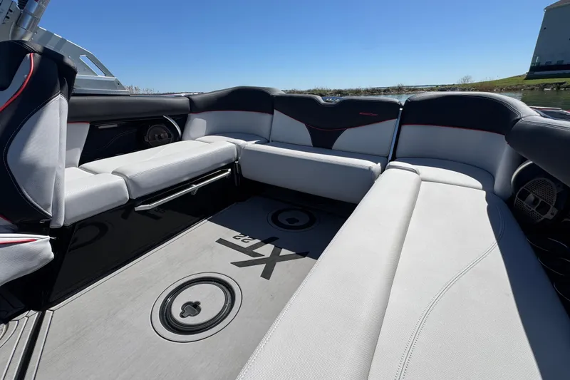 Slide: The Image of 2019 MasterCraft XT22 boat interior with spacious seating and sleek design. - 22