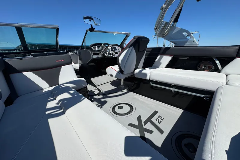 Slide: The Image of 2019 MasterCraft XT22 boat interior with sleek seating and modern dashboard design. - 23