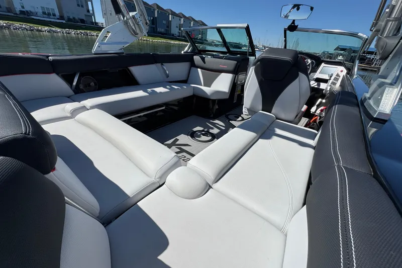 Slide: The Image of 2019 MasterCraft XT22 boat interior with luxurious seating and modern design. - 24