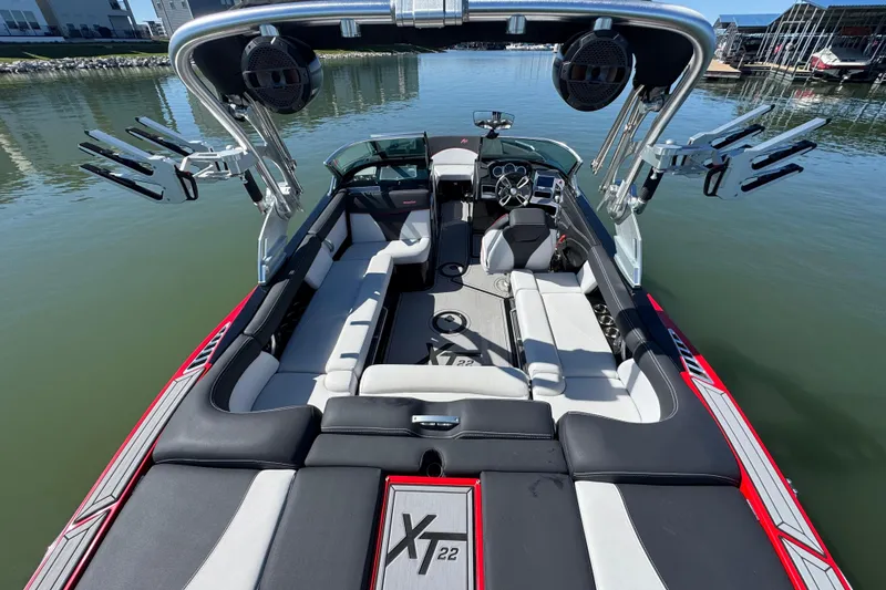 Slide: The Image of 2019 MasterCraft XT22 boat interior with sleek seating and advanced audio system. - 27