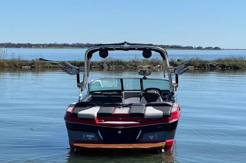 Slide: The Image of 2019 MasterCraft XT22 boat on calm lake with clear blue sky. - 7